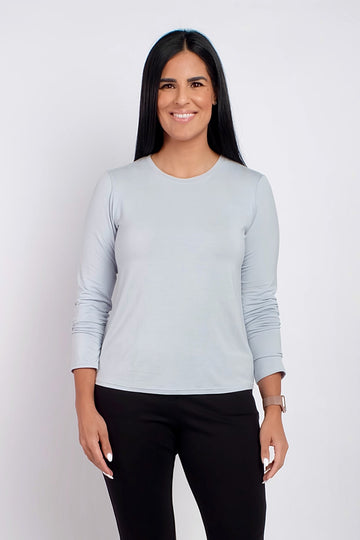 Woman wearing long sleeve light blue work top