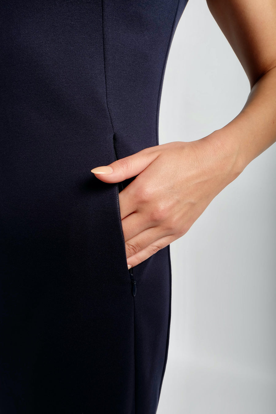 womans hand in dress pocket