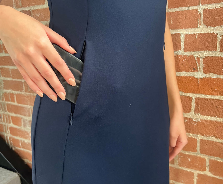 woman putting her phone in her dress pocket