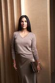 woman wearing cashmere sweater and silk skirt