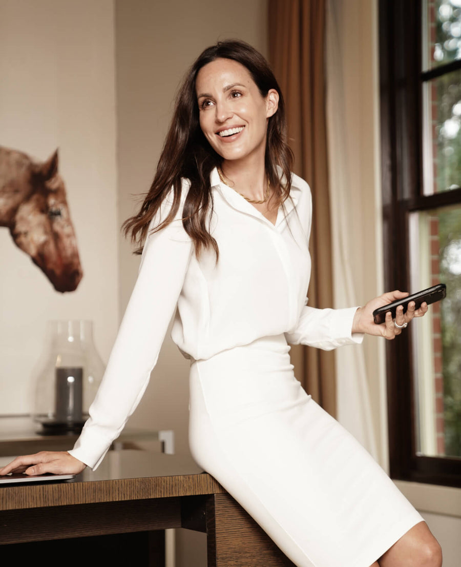 woman wearing white pencil skirt with white long sleeve button up top
