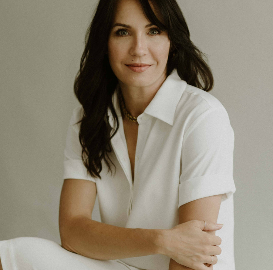 woman wearing short sleeve button up top in white