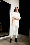 woman wearing all white work outfit