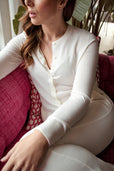 woman wearing white button up sweater