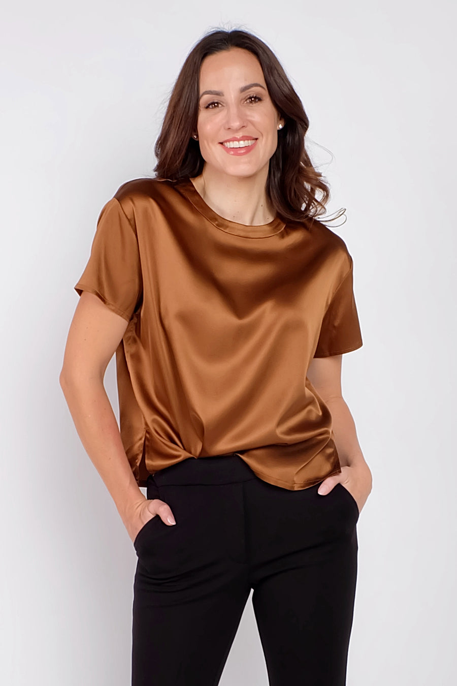 Woman wearing copper short sleeve silk work top