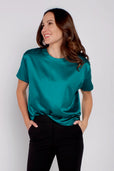 Woman wearing short sleeve turquoise work top