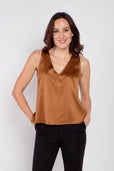 Woman wearing silk copper sleeveless work top