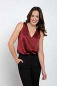 Woman wearing sleeveless burgundy silk work top