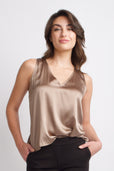woman wearing gold silk sleeveless work top