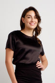 woman wearing short sleeve black silk top