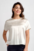 woman wearing short sleeve silk ivory top