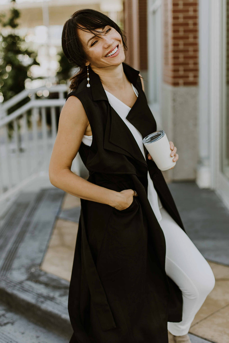 woman wearing long black work vest