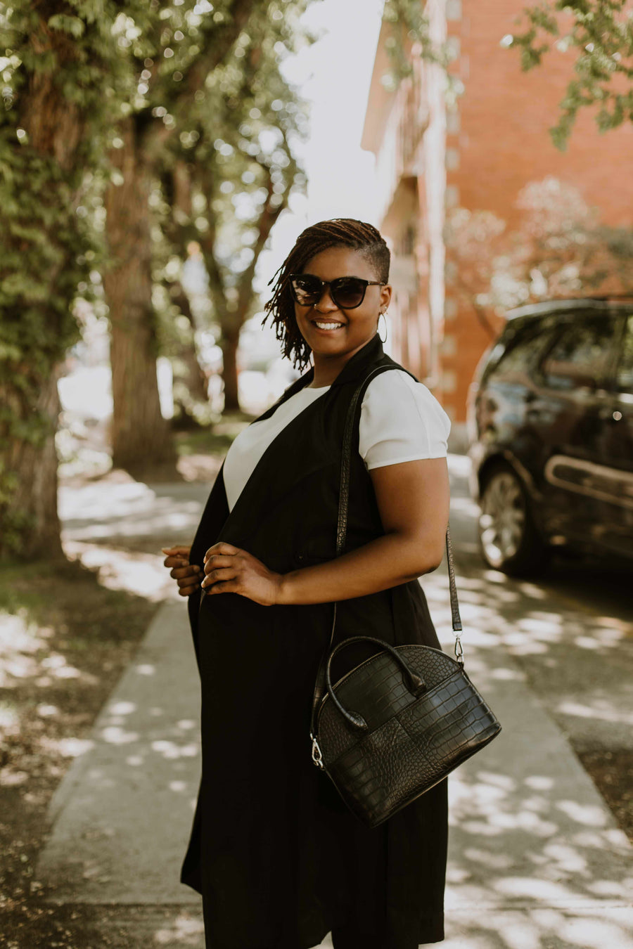 woman wearing white short sleeve top and black vest