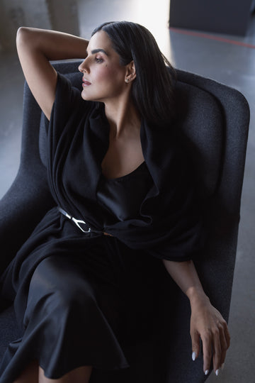 Woman sitting wearing black workwear
