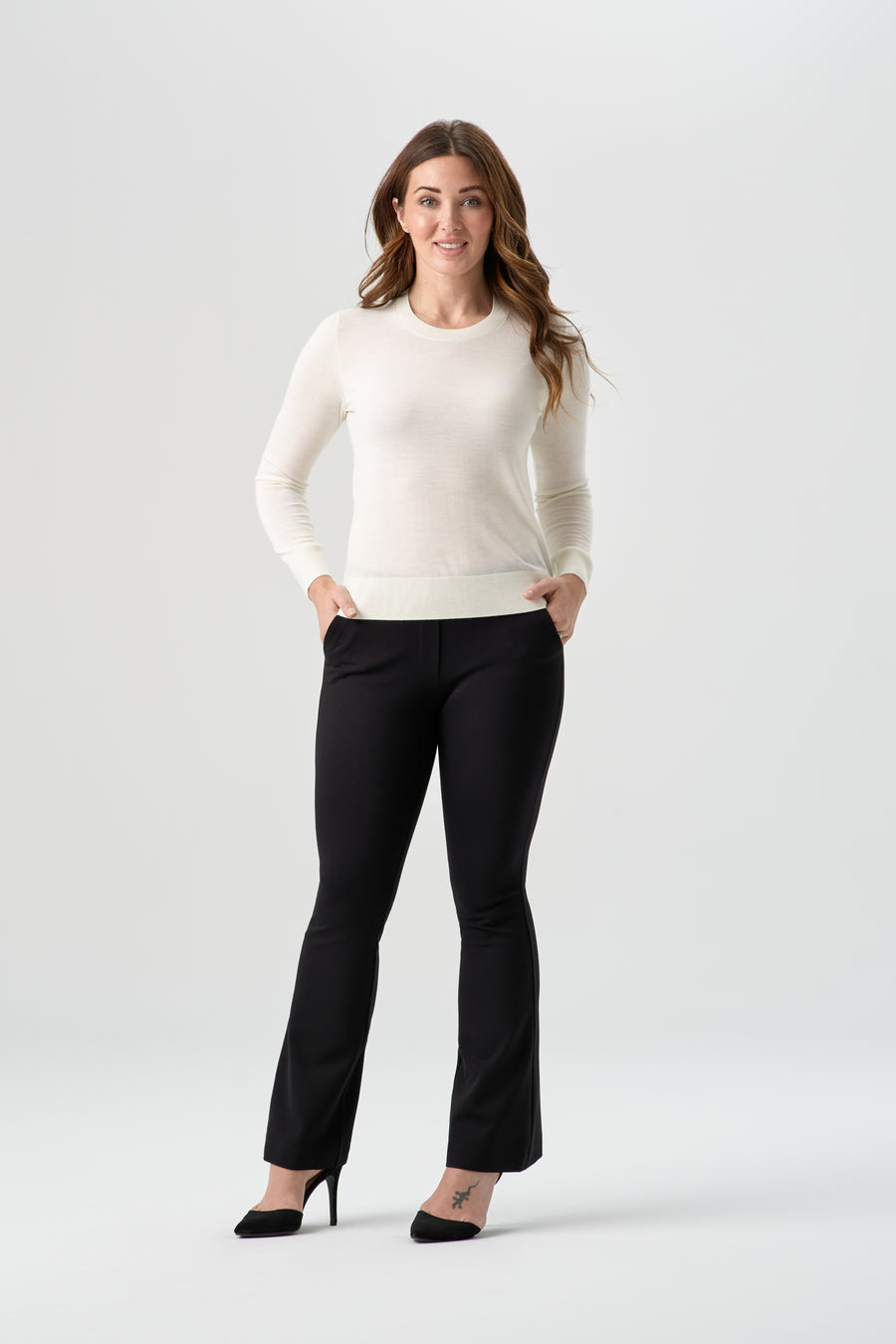 woman wearing white cardigan with black pants