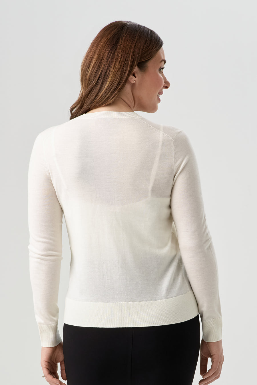 woman wearing white button up cardigan with black pencil skirt