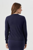 woman wearing navy blue button up cardigan with navy blue skirt