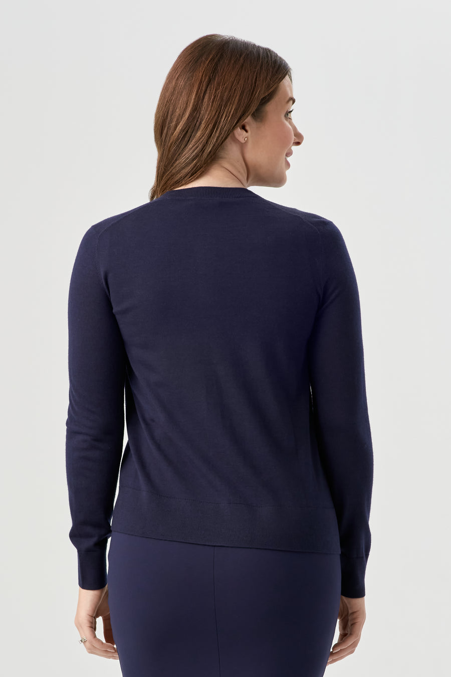 woman wearing navy blue button up cardigan with navy blue skirt