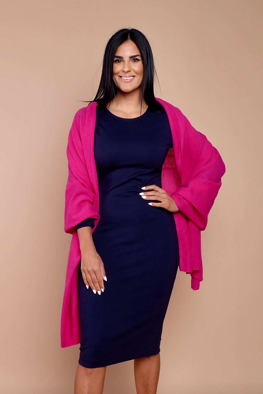 woman wearing navy blue work dress with pink sweater